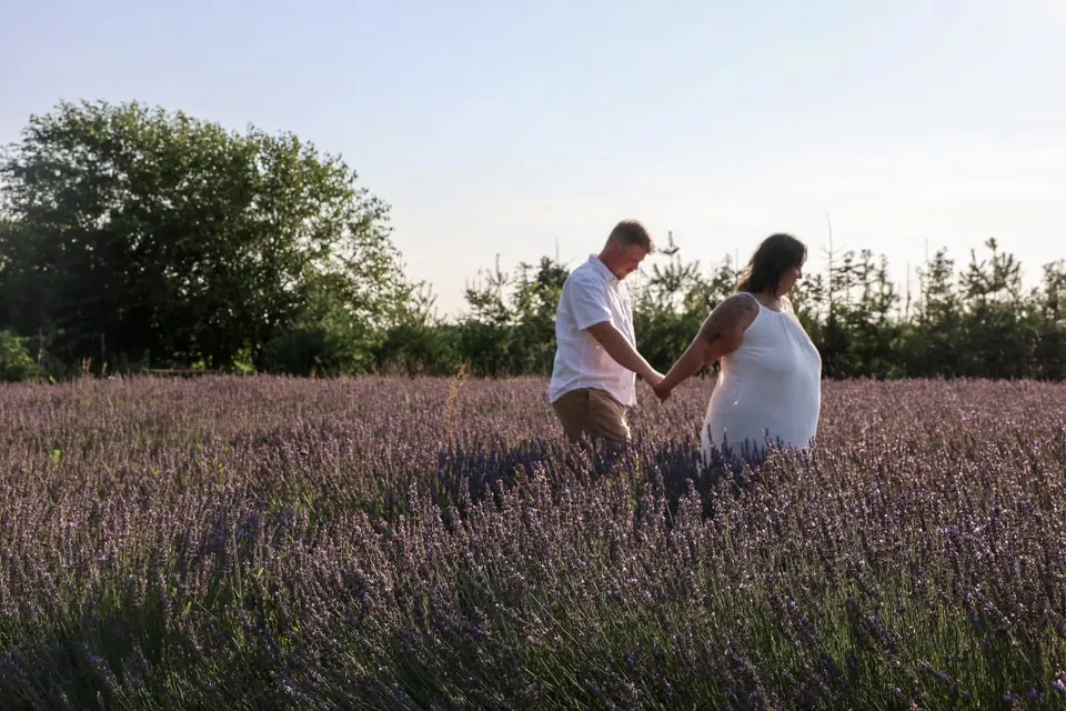 A couple walking through a lavender field